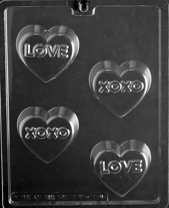 Picture of chocolate mold for making heart-shaped chocolate covered cookies.  This heart shaped mold includes 4 cavities. Two of the cavities have LOVE imprinted on them. Two of the cavities have XOXO imprinted on them.