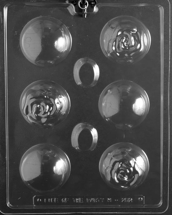 picture of chocolate mold for making hot cocoa bombs or bath bombs. Mold has 6 cavities. 3 of the cavities are imprinted with a rose shape on the top