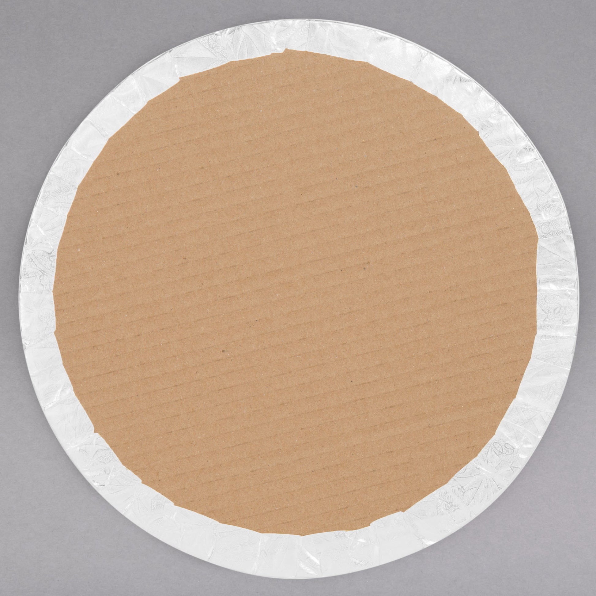 image of the back of a 12 inch white round cake drum that is a qtr inch thick